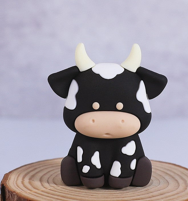 Zwarte koe taarttopper figuur uit de jungle set